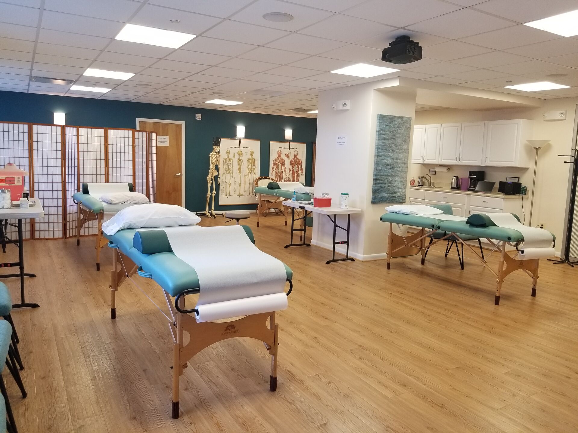 The community acupuncture room at The Teal Center Arlington with treatment tables set up