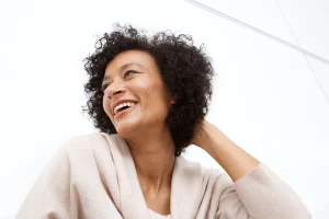 A woman smiling with healthy, radiant skin